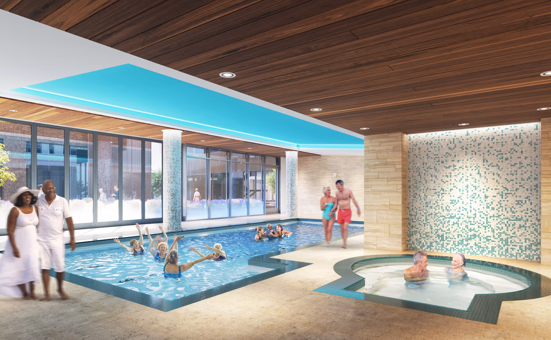 Indoor swimming pool area with several elderly people enjoying the water. Some are swimming and raising their arms, while others are relaxing in a round hot tub. A couple in swimwear walks beside the pool, and another couple dressed in white walks nearby. The room features large windows, a wooden ceiling, and a tiled wall with blue and white mosaic patterns.