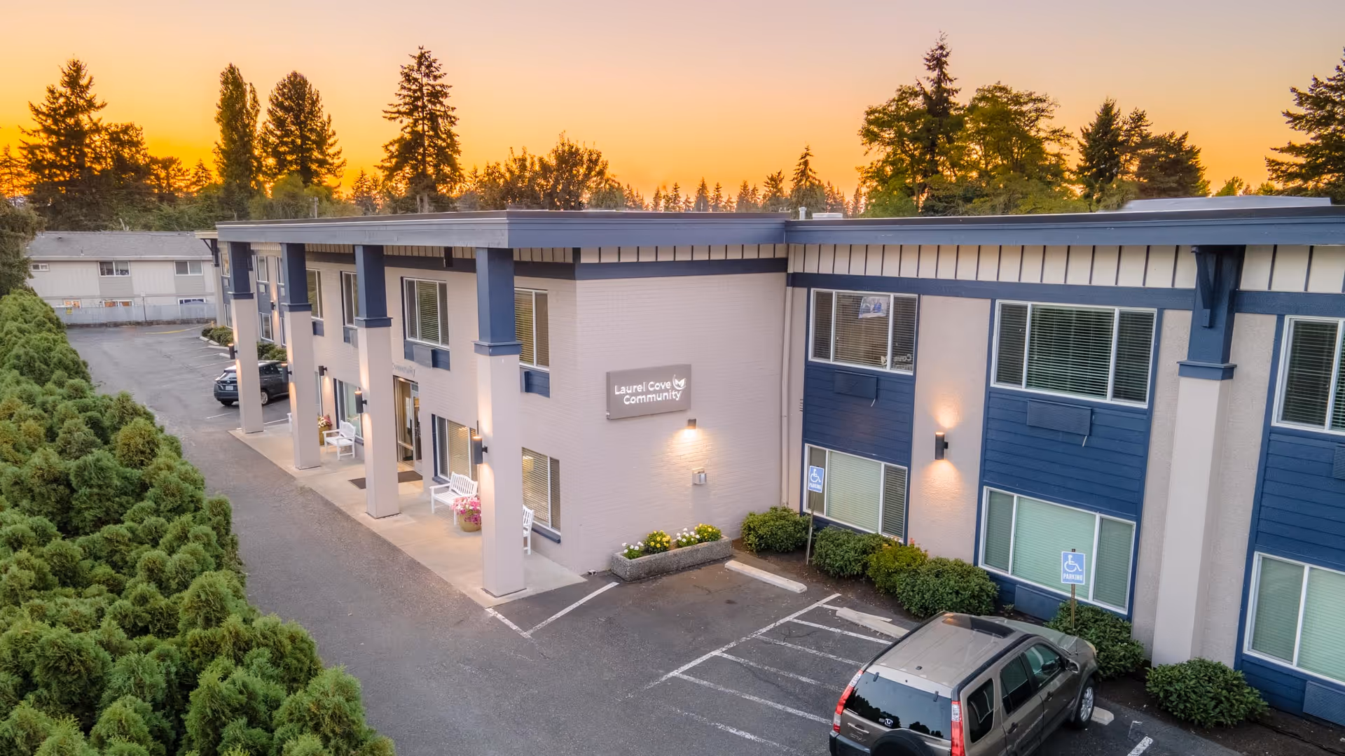 Exterior view of Laurel Cove Community Assisted Living building with parking and entrance.