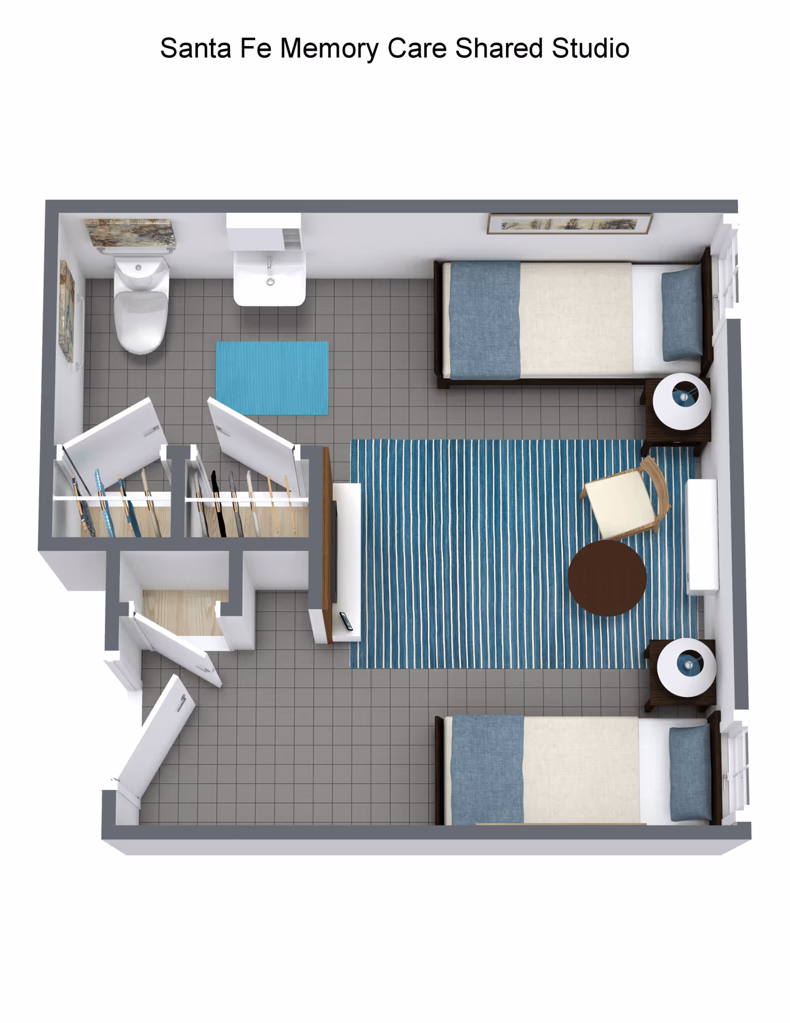 Top-down view of a shared studio memory care room with two single beds, each with a blue and beige bedspread and a pillow. Between the beds is a blue striped rug, a round wooden table, and a chair. Each bed has a nightstand with a lamp. The room includes a small bathroom with a toilet, sink, and a blue bath mat. There are two closets near the entrance.