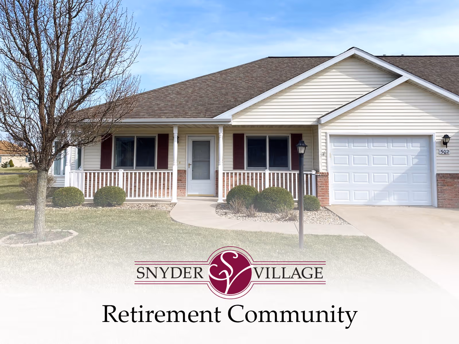 Front exterior of a single-story retirement community home with a porch, attached garage, and lawn, with the facility logo overlaid at the bottom.