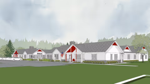Illustration of a single-story senior living facility building with white walls, gray roofs, and red accents around the entrances. The building is surrounded by green grass and trees under a cloudy sky.