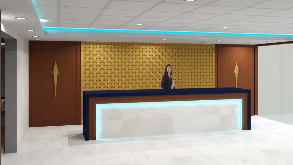 Reception area with a modern desk featuring blue and white marble design with glowing blue lights. A woman stands behind the desk. The background has a gold textured wall and two wooden doors with gold decorative handles. The floor is white marble and the ceiling has recessed lighting with blue accent lights.