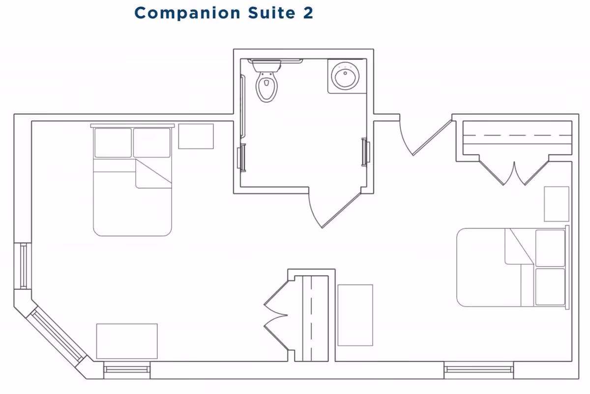 Floor plan layout of Companion Suite 2 at The Heritage Memory Care, showing two bedrooms each with a bed and nightstand, a shared bathroom with a toilet and sink, and closets.