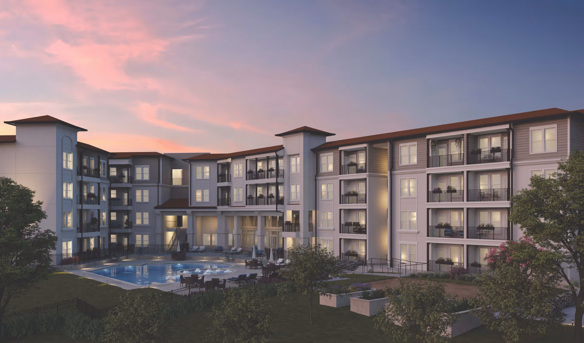 Exterior view of a multi-story senior living facility named Sage Stone Oak at dusk, featuring balconies, lit windows, a swimming pool, patio seating, and surrounding greenery under a pink and purple sky.