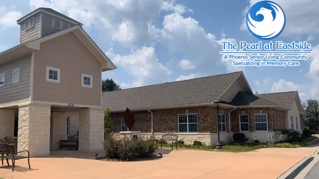 Exterior view of a single-story senior living building with brick facade and courtyard.