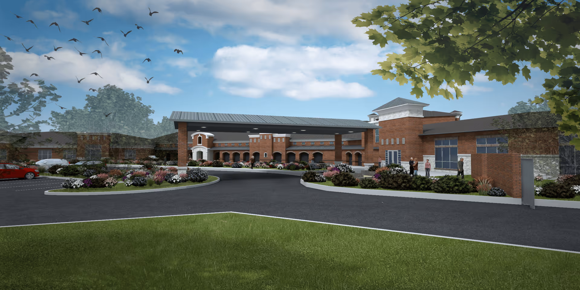 Exterior view of a senior living facility with a circular driveway, landscaped flower beds, and a brick building under a partly cloudy sky with birds flying.