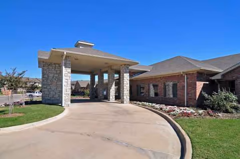 Exterior view of Emerald Hills Rehabilitation and Healthcare Center entrance with driveway and landscaping.