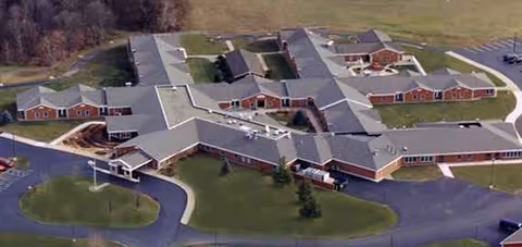 Aerial view of Maple Lawn Medical Care Facility with interconnected red-brick wings