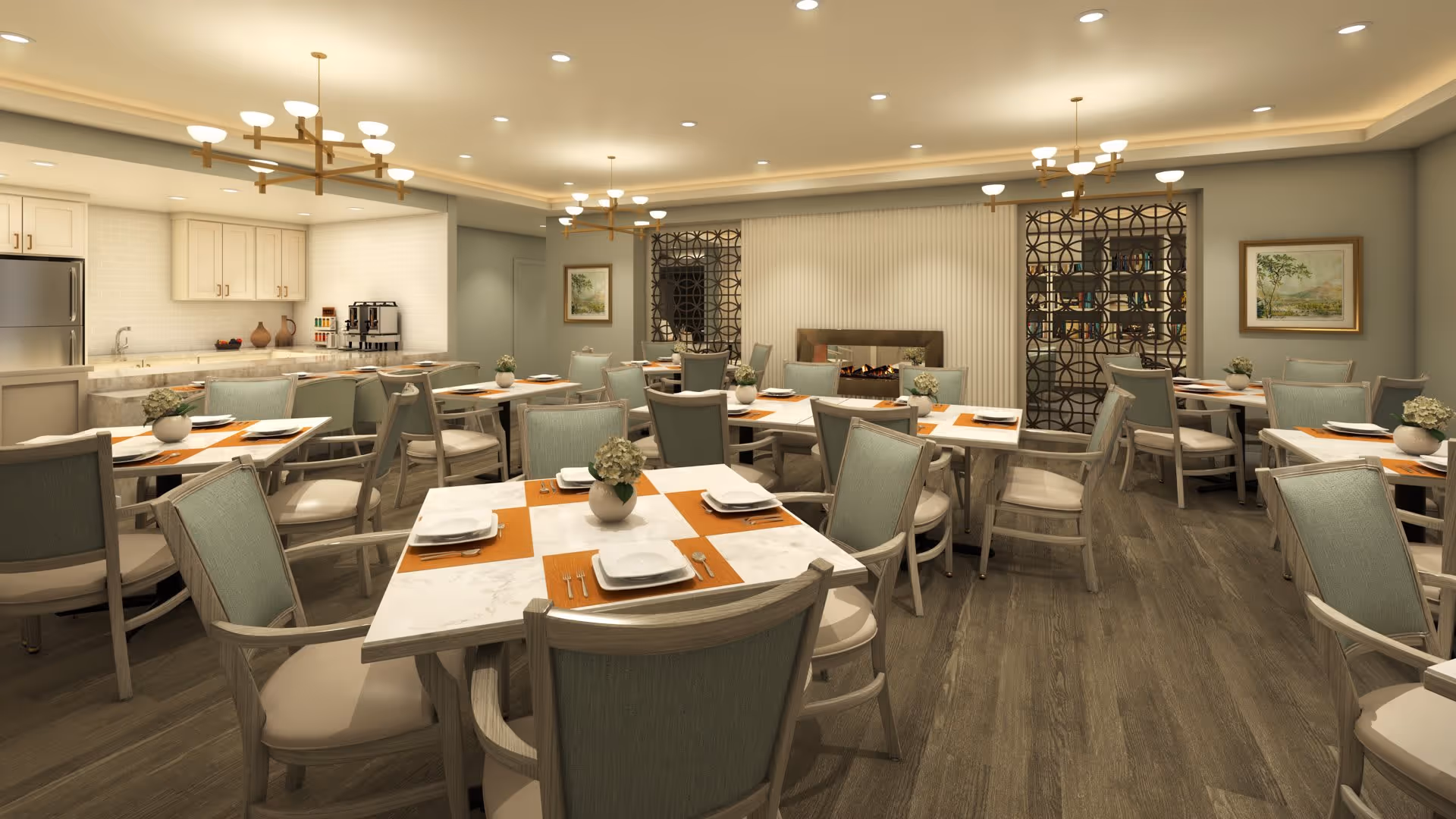 A spacious dining room with multiple tables set with white plates, silverware, and orange placemats. Each table has a small vase with flowers. The room features light green cushioned chairs, wooden flooring, modern chandeliers, and a kitchen area with white cabinets and a stainless steel refrigerator in the background. There is decorative wall art and a fireplace with a decorative screen on one wall.