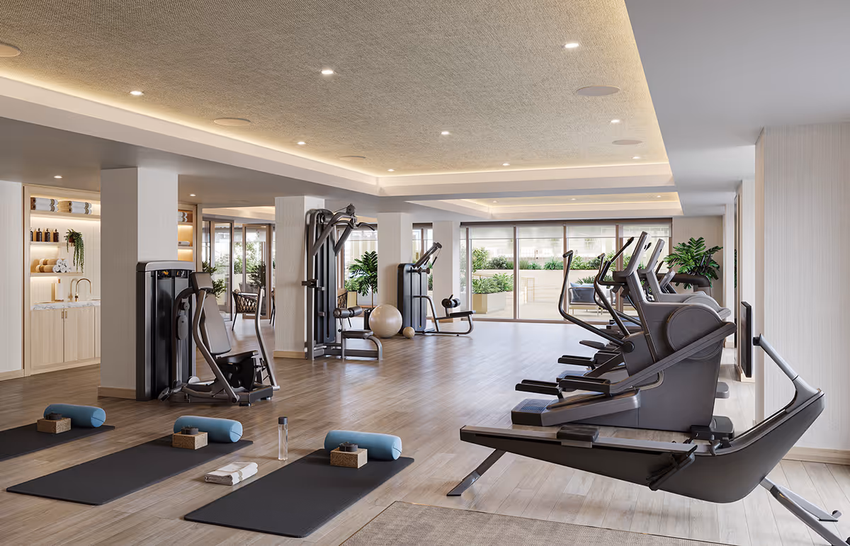 Bright, modern fitness center with treadmills, weight machines, and yoga mats arranged in a spacious room with large windows.