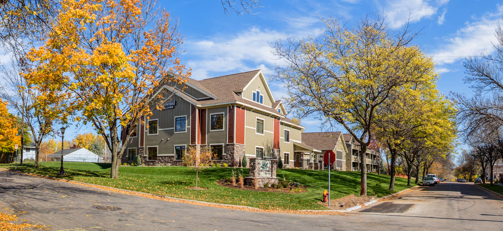 Gracewood Advanced Assisted Living exterior with fall foliage and a multi-story building