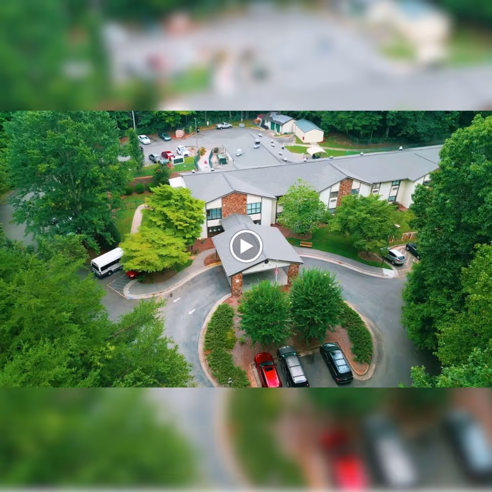Aerial view of the Mill Creek Center for Nursing and Rehabilitation surrounded by trees and parking areas.