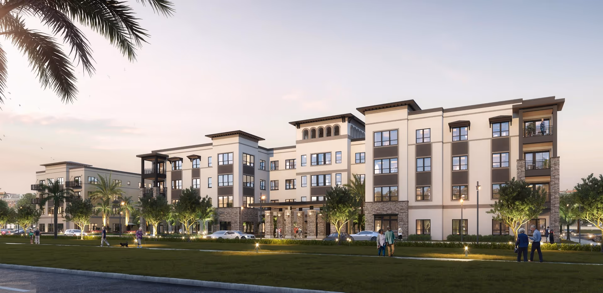 Exterior view of a modern, multi-story senior living facility named Grand Living at Naples, surrounded by palm trees and landscaped greenery with people walking and socializing on the lawn in front of the building during early evening.