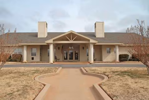 Front view of a single-story senior living facility with a central entrance.