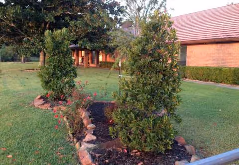 Front exterior of Lakehouse on Dixie with a brick building, red roof, and landscaped entrance.