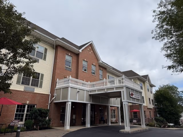 Exterior view of Merry Heart Assisted Living facility showing the entrance and surrounding landscaping.