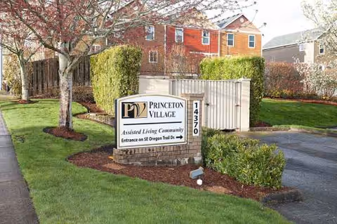 Exterior view of Princeton Village by Cogir sign with landscaping and residential buildings.