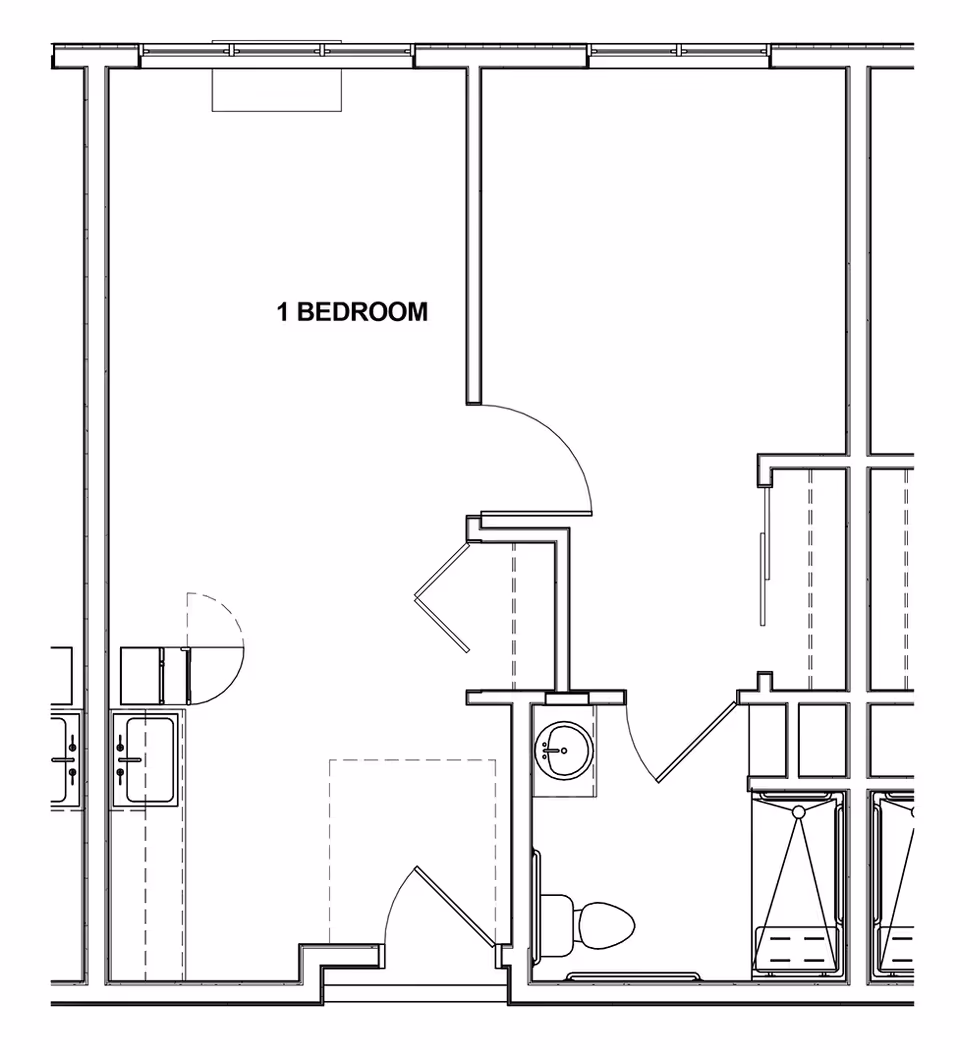 Architectural floor plan of a one-bedroom unit showing the layout including a bedroom, bathroom with toilet and sink, and kitchen area with a sink and stove.