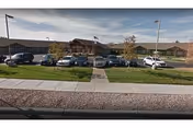 Exterior view of Clarkson Health Care with a parking lot and American flag.