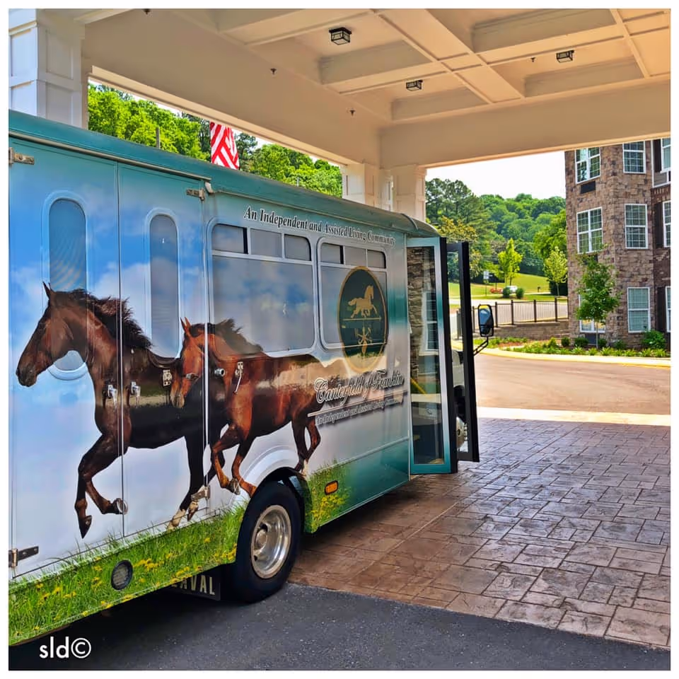 A horse-themed Canterfield Senior Living shuttle parked under the covered entrance of a senior living building.