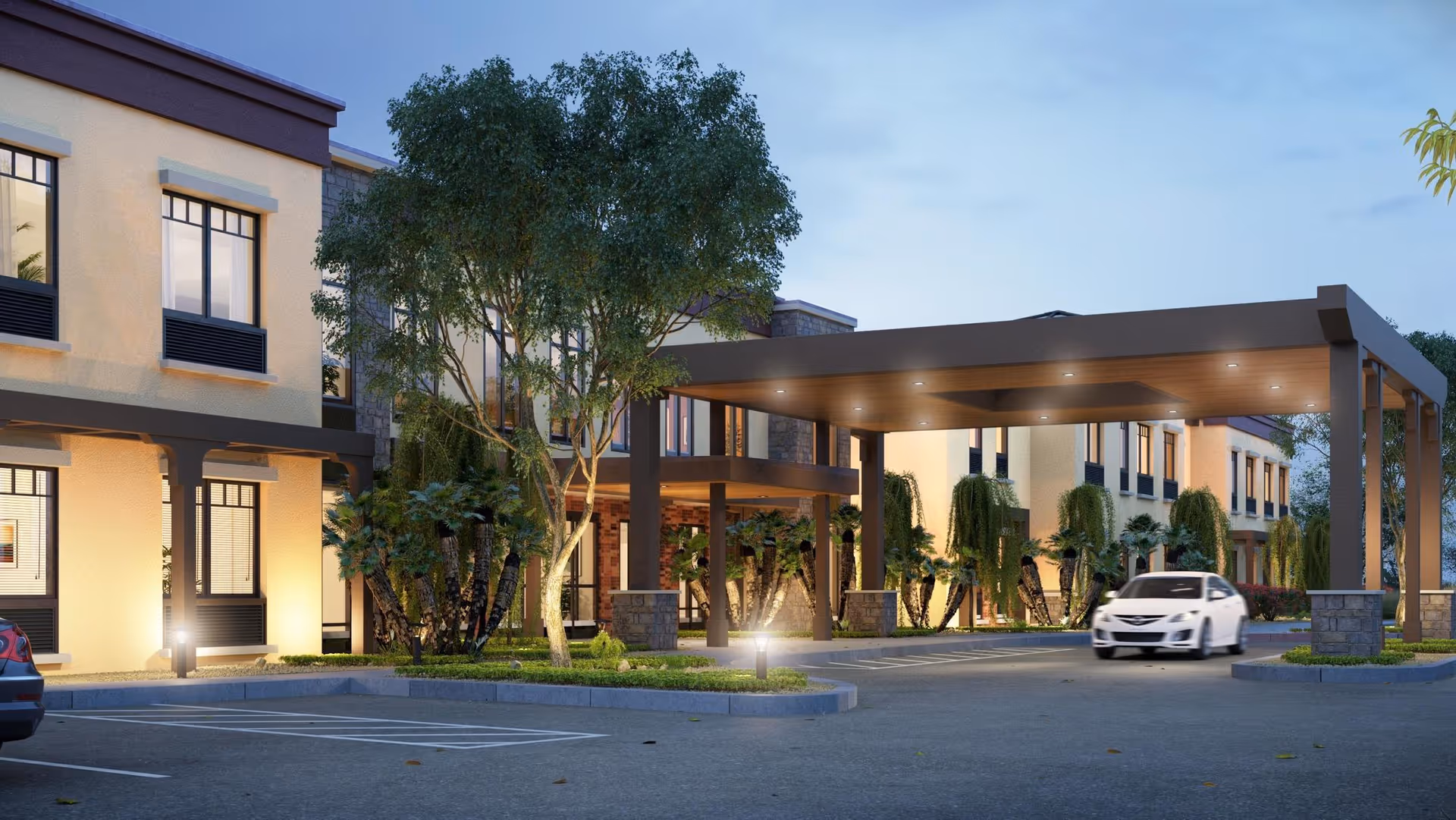 Covered porte-cochère and driveway in front of a two-story senior living building with trees, landscaping, and a car.