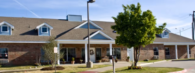 Front view of Abba Care Assisted Living B building with brick exterior and entrance.