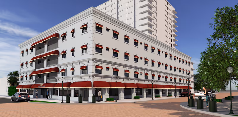 Exterior view of a white multi-story assisted living building with red awnings along the sidewalk and a taller tower rising behind it.