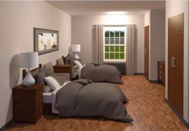 Two twin beds in a furnished bedroom with nightstands, lamps, a window, and wood flooring.
