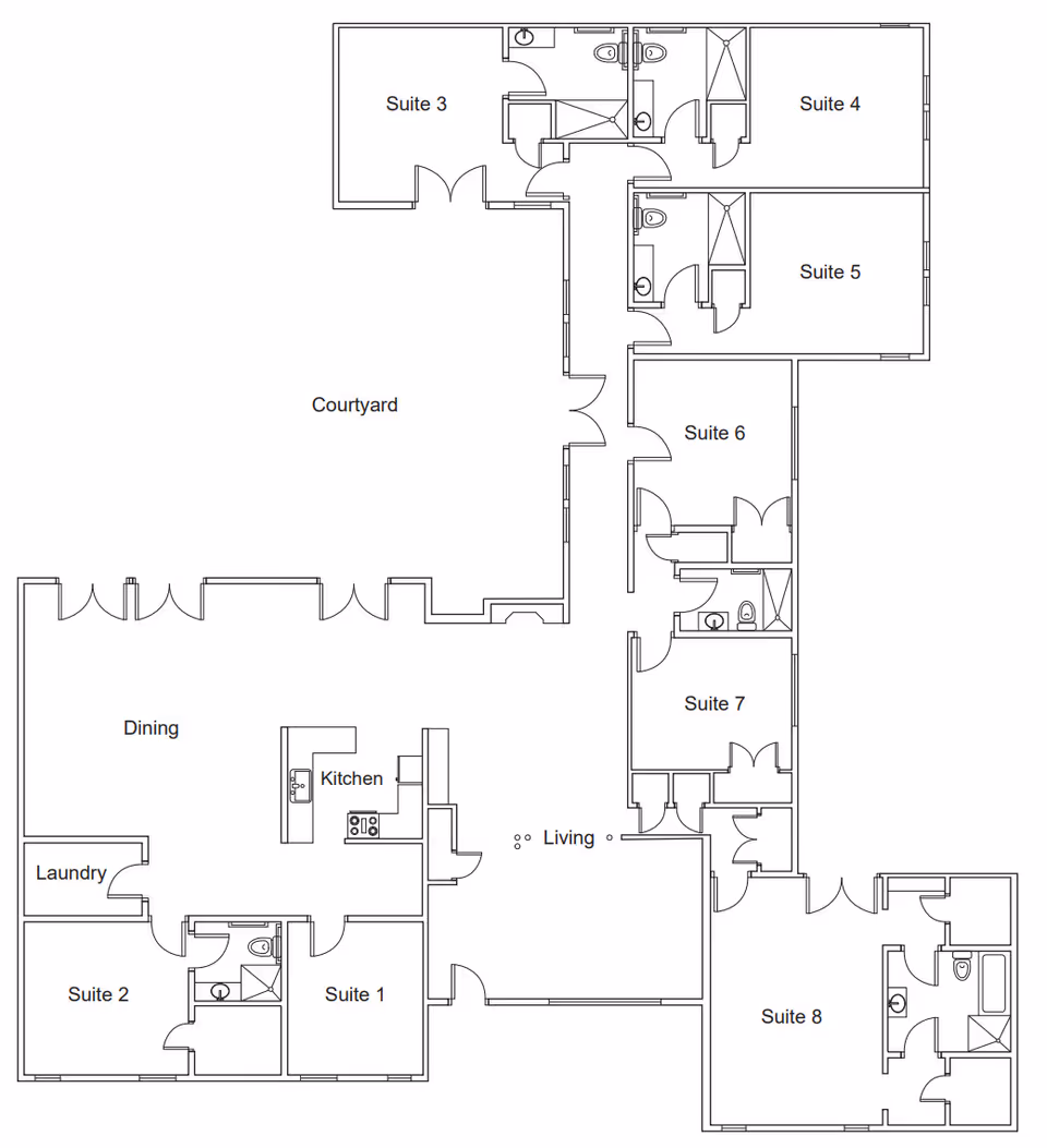 Black-and-white floor plan labeled with suites, a courtyard, dining, kitchen, living area, and laundry for the facility.