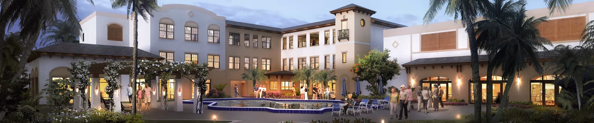 Exterior view of Cascades at Delray Beach senior living facility during dusk, showing a large, well-lit building with multiple windows, palm trees, a central courtyard with a fountain, and several people walking and socializing outdoors.