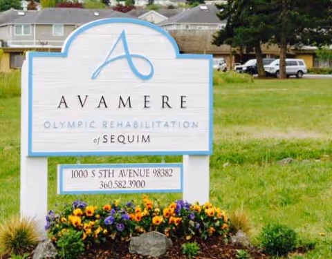 An outdoor sign for Avamere Olympic Rehabilitation of Sequim with colorful flowers.