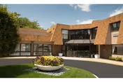 Exterior view of Bear Mountain at Reading facility entrance with circular driveway and flower bed