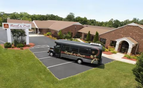 Aerial view of Runk & Pratt Leesville Road exterior with a bus parked in front