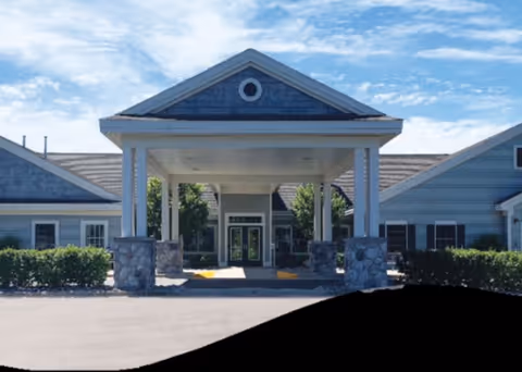 Exterior view of Newberry Assisted Living Community entrance with a covered porte-cochere.