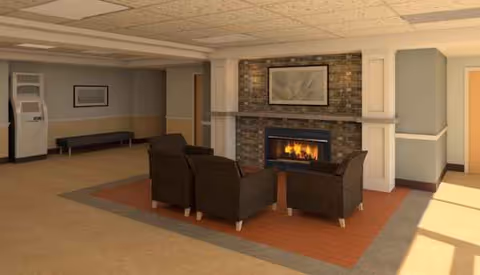 Lounge area with fireplace, seating, and modern decor in a senior facility.