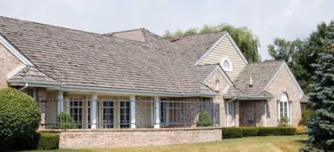 One-story brick building exterior with a covered entrance and manicured lawn.