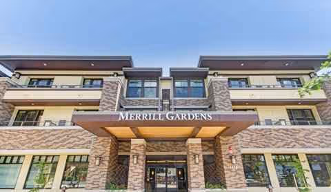 Exterior front view of Merrill Gardens at Lafayette entrance with stone facade and glass doors.