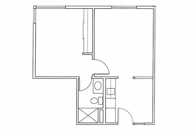 Black and white architectural floor plan showing a layout with two main rooms, a bathroom with a toilet and shower, and a kitchen area with a sink and counter space.