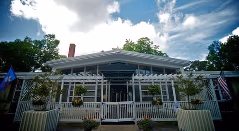 Front exterior view of Cardinal Care of Jacksonville with a covered entrance and potted plants.