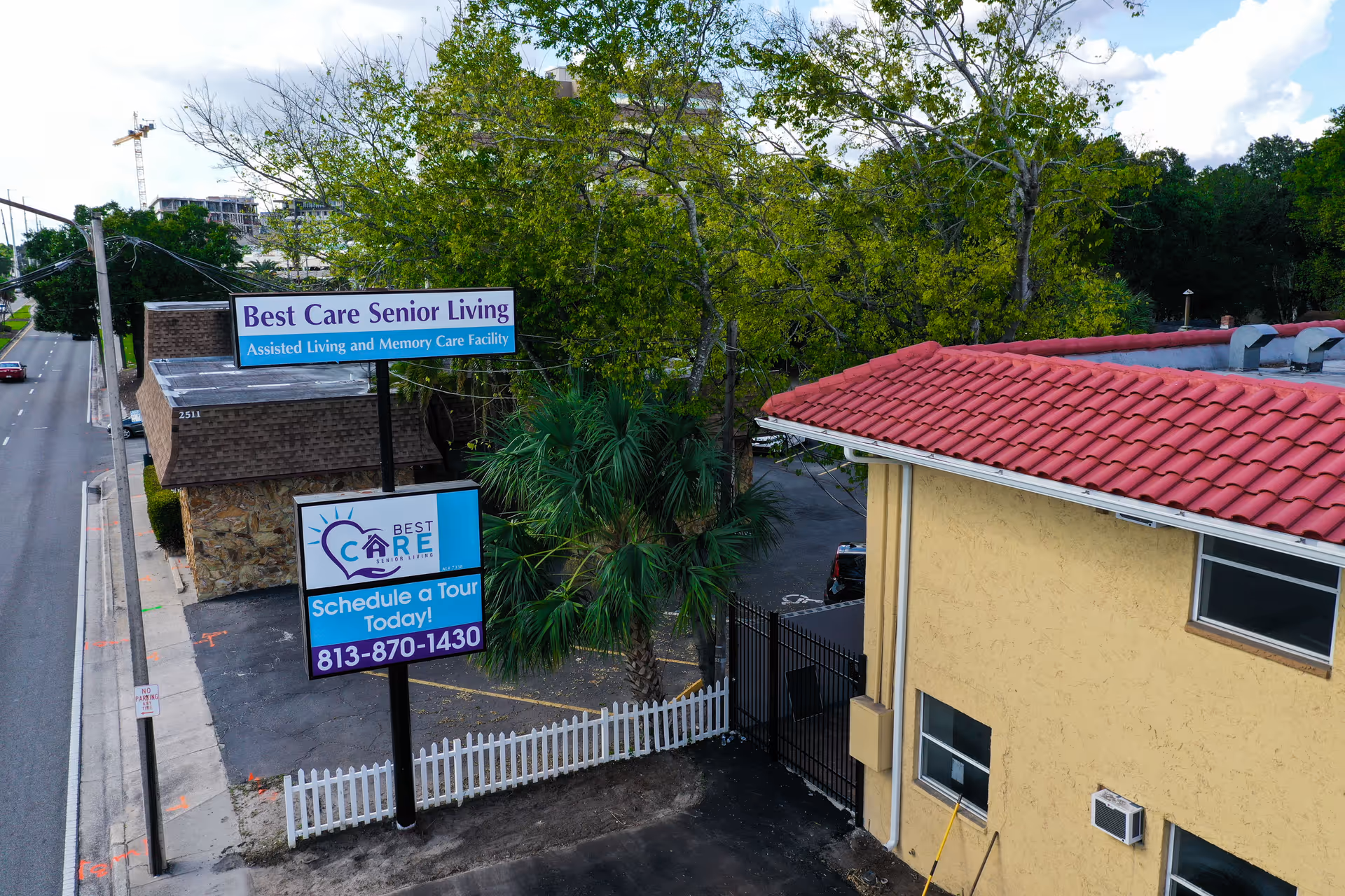 Aerial view of Best Care Senior Living building exterior with signs near street.