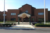 Front view of Northampton Manor Nursing and Rehabilitation Center with brick facade and entrance canopy.