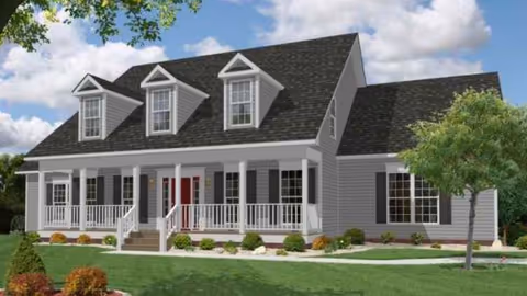 Facade of a large gray house-like senior living facility with a covered porch.