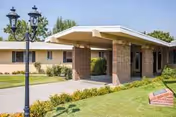 Exterior view of Kingsburg Care Center with a covered entrance and landscaped path.