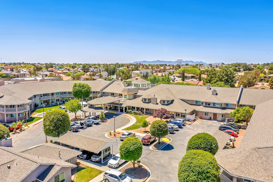 Aerial view of the Solstice Senior Living at Rio Norte complex showing buildings arranged around a circular driveway, parking areas, and surrounding neighborhood.