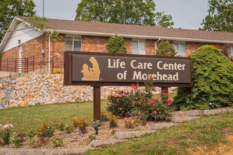 Front view of Life Care Center of Morehead sign beside brick building and landscaped garden.
