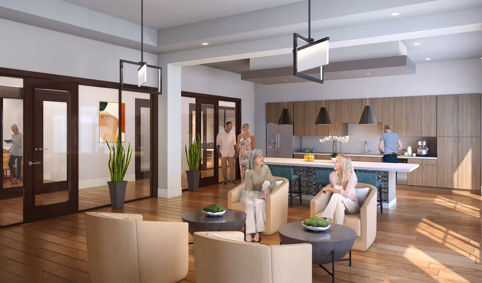 A modern, open-concept living area with a kitchen and seating space. Two women are seated and conversing in beige armchairs around round coffee tables with decorative plants. In the background, a man is preparing something in the kitchen, which features wooden cabinets, a large island with bar stools, and pendant lights. A couple is walking through glass double doors, and another woman is visible in a room beyond the doors. The space has wooden flooring, potted plants, and contemporary lighting fixtures.