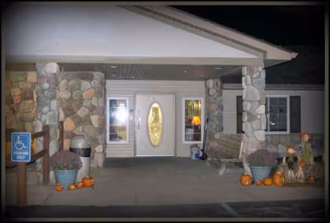 Front entrance of Medilodge of Hillman with pumpkins and autumn decorations at night