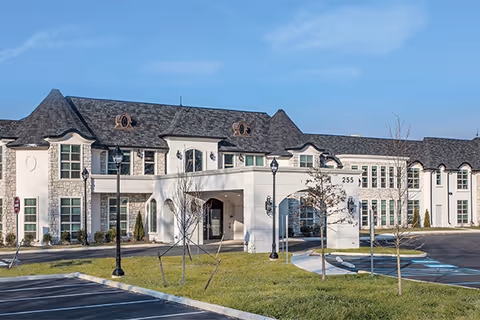 Exterior view of The Remington of Yardley front entrance with lawn and parking.