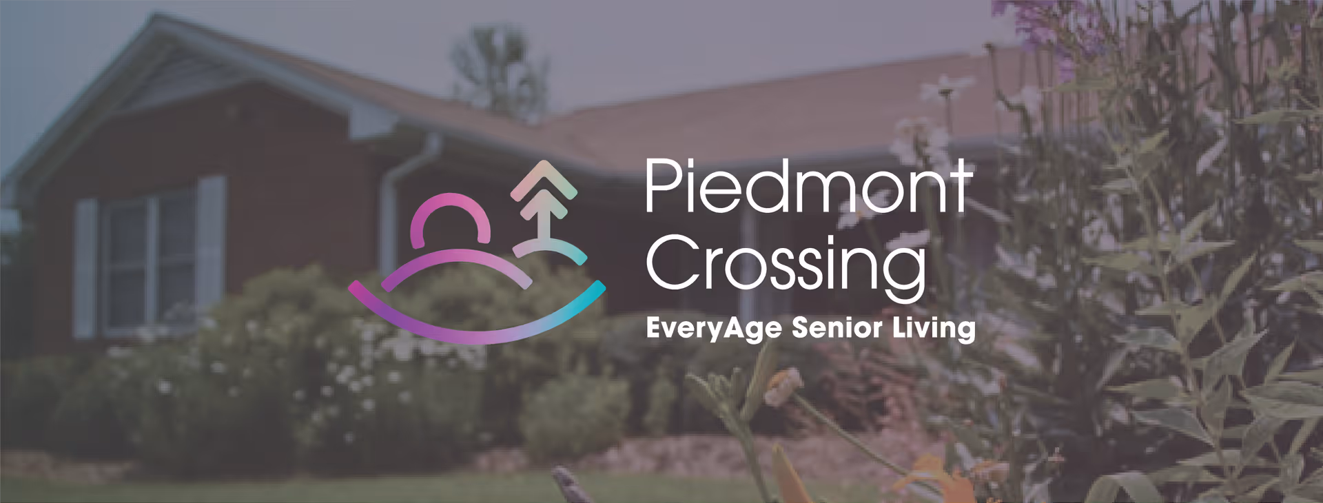 Front view of a single-story brick senior living building and garden with a large Piedmont Crossing logo and 'EveryAge Senior Living' text overlaid.