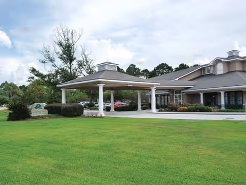 Front view of Gardenview Assisted Living with a covered entrance and green lawn.